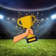 Ein goldener Pokal vor einem Fußballstadion